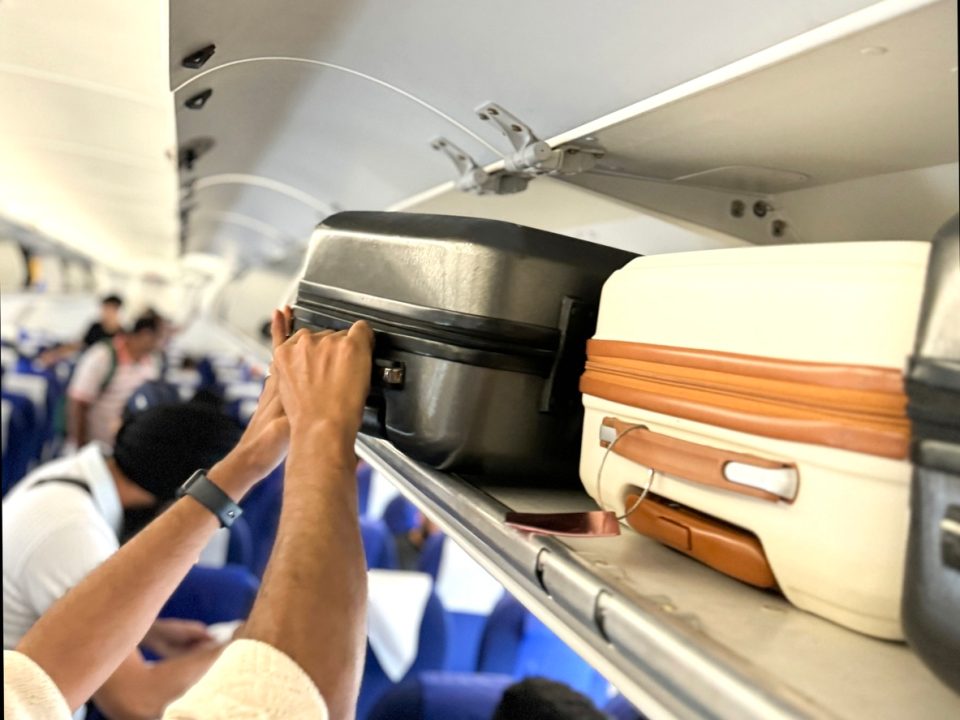The Ultimate Trick to Secure Overhead Bin Space on Flights, Says Experts