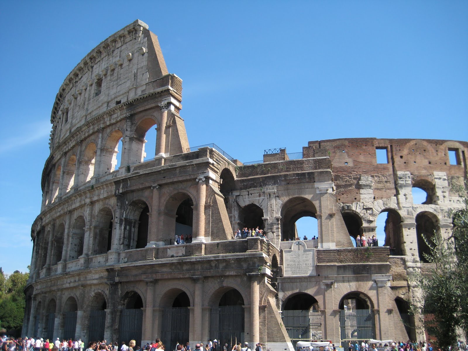 Ancient Roman ruins in the heart of Rome with tourists walking among the structures